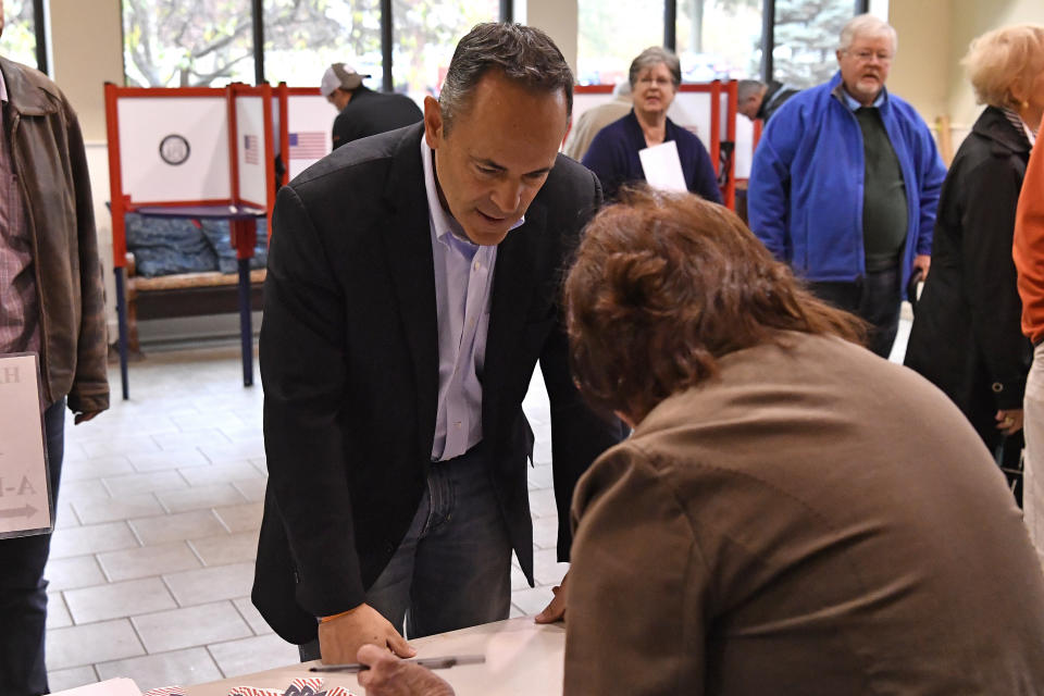 Kentucky Governor and Republican gubernatorial candidate Matt Bevin signs in to receive his ballot to cast his ballot in the state's general election in Louisville, Ky., Tuesday, Nov. 5, 2019. (AP Photo/Timothy D. Easley)