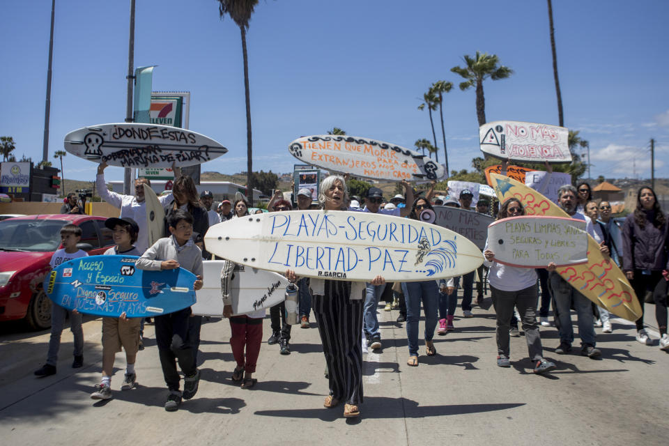 Locals march to protest the disappearance of foreign surfers in Ensenada, Mexico, Sunday, May 5, 2024. Mexican authorities said Friday that three bodies were recovered in an area of Baja California near where two Australians and an American went missing last weekend during an apparent camping and surfing trip. (AP Photo/Karen Castaneda)