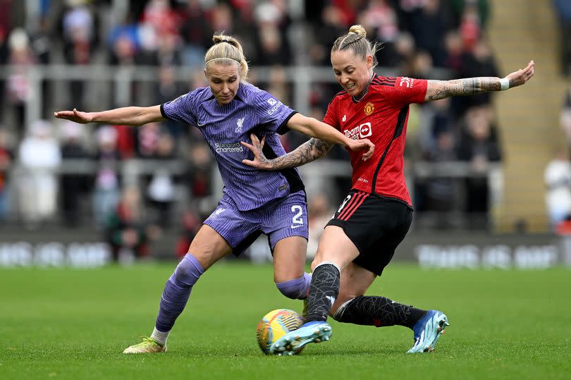 Emma Koivisto of Liverpool and Leah Galton of Manchester United in action during the Barclays Women´s Super League match between Manchester United and Liverpool FC  at Leigh Sports Village on December 17, 2023 in Leigh, England.