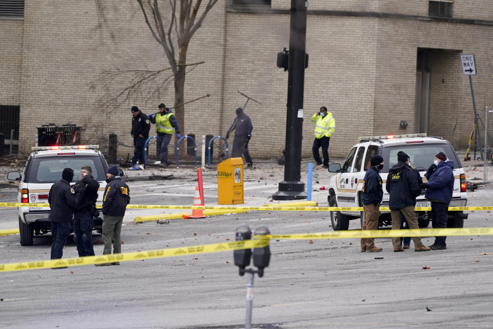 Emergency personnel work near the scene of an explosion in downtown Nashville, Tenn., Friday, Dec. 25, 2020. Buildings shook in the immediate area and beyond after a loud boom was heard early Christmas morning.(AP Photo/Mark Humphrey)