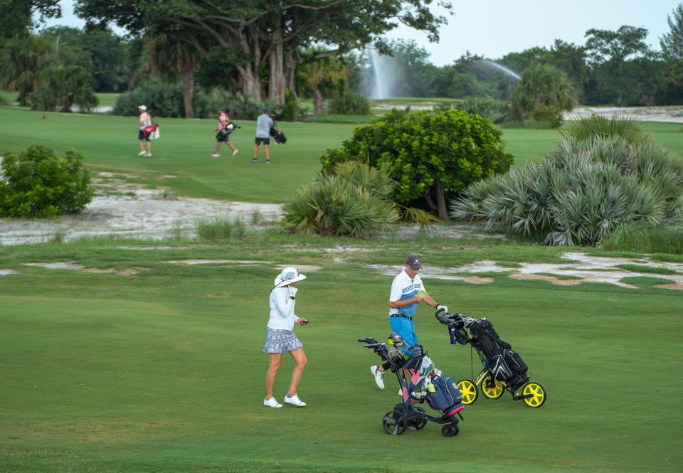 Diane and Larry Garrett walk the course as they play a round of golf at The Park in West Palm Beach, Florida on June 30, 2023.