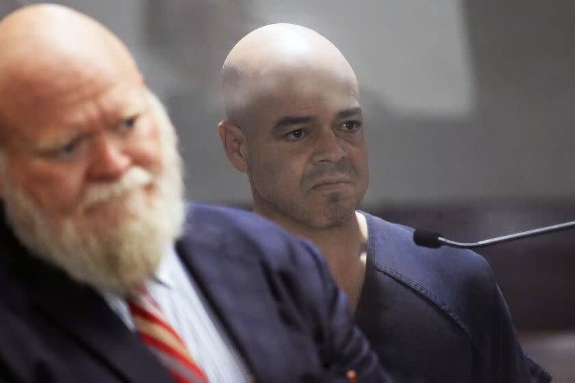 Clark County Public Administrator Robert "Rob" Telles, right, appears in court with attorney Travis E. Shetler, left, Thursday, Sept. 8, 2022, in Las Vegas. Telles was arrested Wednesday in the fatal stabbing of Las Vegas Review-Journal reporter Jeff German, whose investigations of the official's work preceded his primary loss in June. (AP Photo/John Locher)