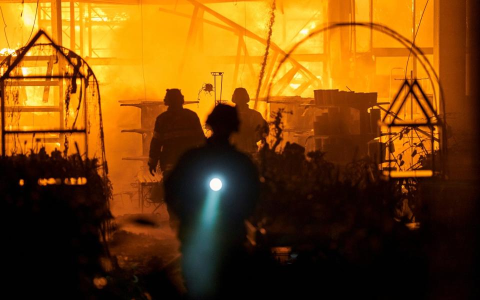 Emergency workers attend the blaze - AP Photo/LIBKOS