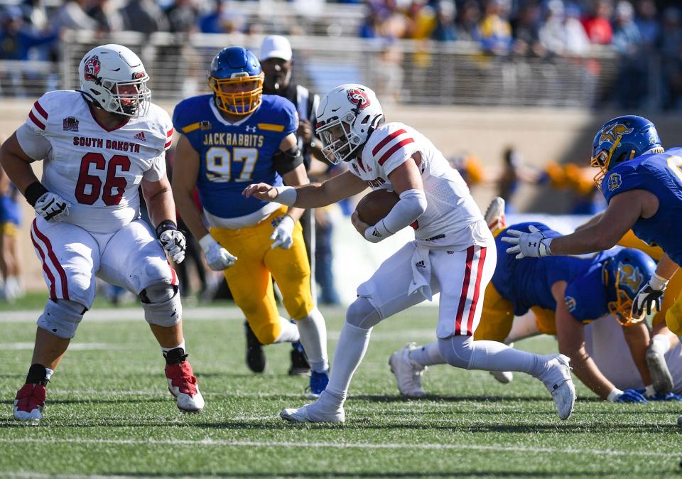 South Dakota quarterback Carson Camp carries the ball in a football game against South Dakota State on Saturday, October 8, 2022, at Dana J. Dykhouse Stadium in Brookings.