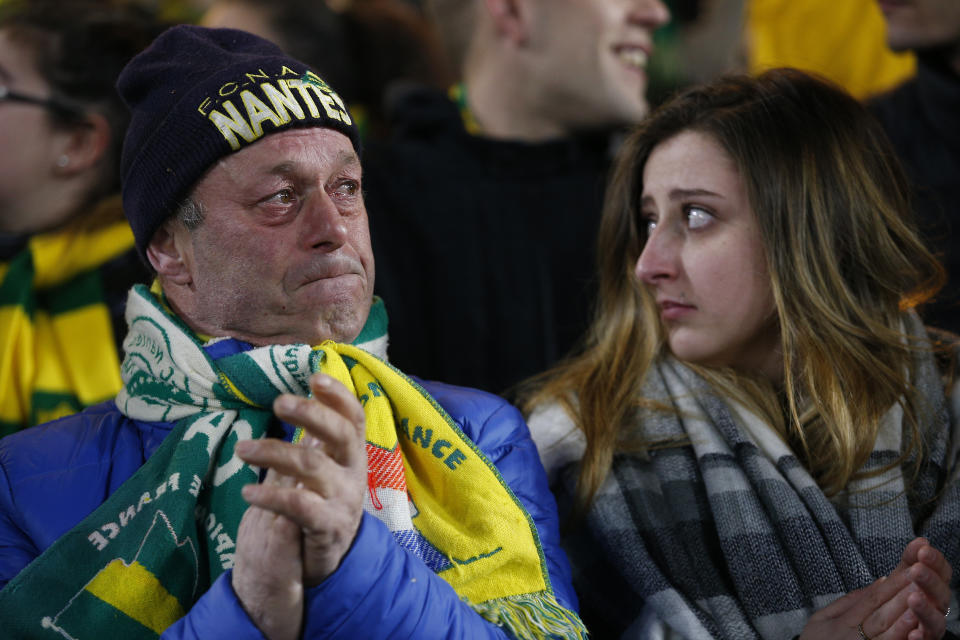 A Nantes soccer supporters cries during an homage to Argentinian player Emiliano Sala in La Beaujoire stadium before the French League One soccer match Nantes against Saint-Etienne, in Nantes, western France, Wednesday, Jan.30, 2019. Sala disappeared over the English Channel on Jan. 21, 2019 as it flew from France to Wales. Sala had just been signed by Premier League club Cardiff. (AP Photo/Thibault Camus)