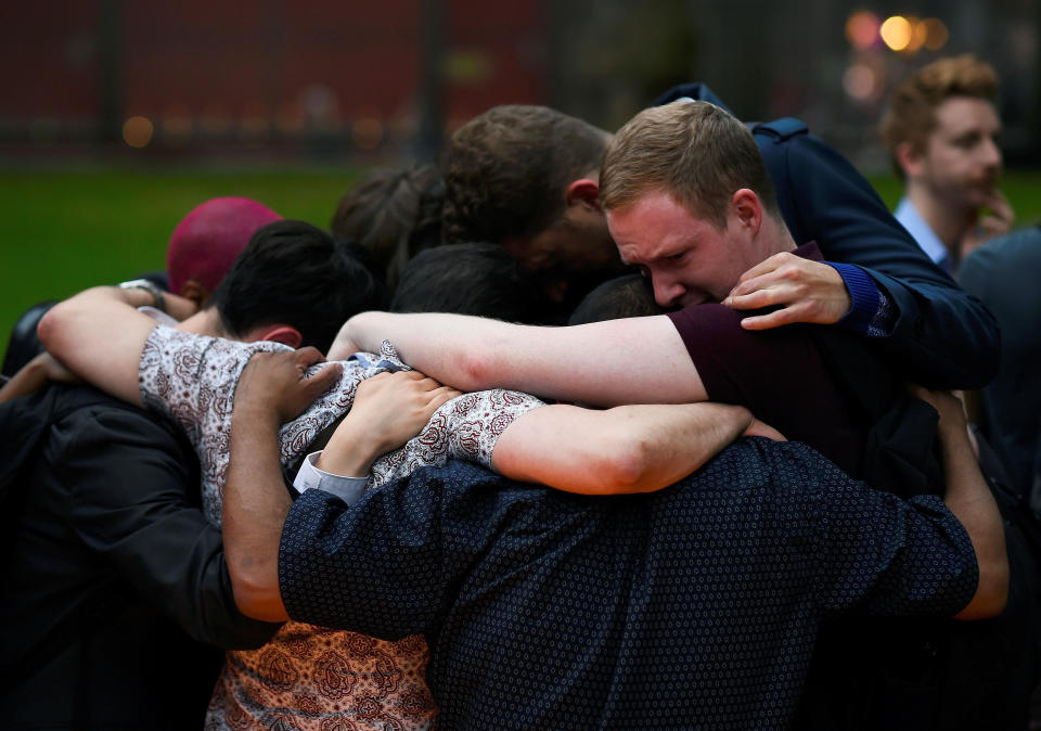 Mourners embrace during a vigil, in memory of the victims of the gay nightclub mass shooting in Orlando, at St Anne's Church in the Soho district of London, Britain June 13, 2016.