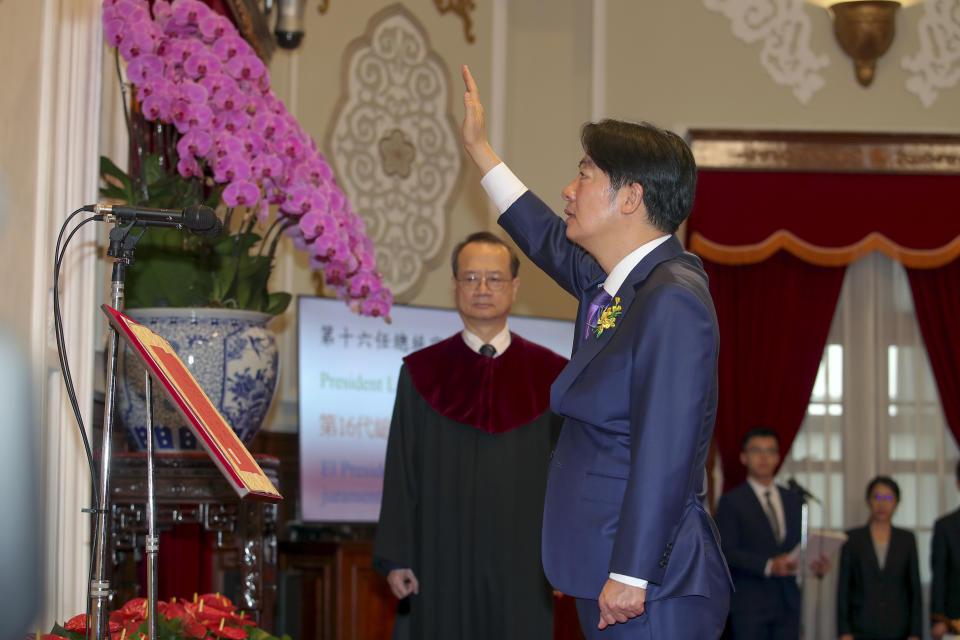 In this photo released by the Taipei News Photographer, President-elect Lai Ching-te, also known by his English name William, gets sworn in as Taiwan's new president during his inauguration ceremony in Taipei, Taiwan, Monday, May 20, 2024. Lai was sworn in as Taiwan's new president Monday, beginning a term in which he is expected to continue the self-governing island's policy of de facto independence from China while seeking to bolster its defenses against Beijing. (Taipei News Photographer via AP)
