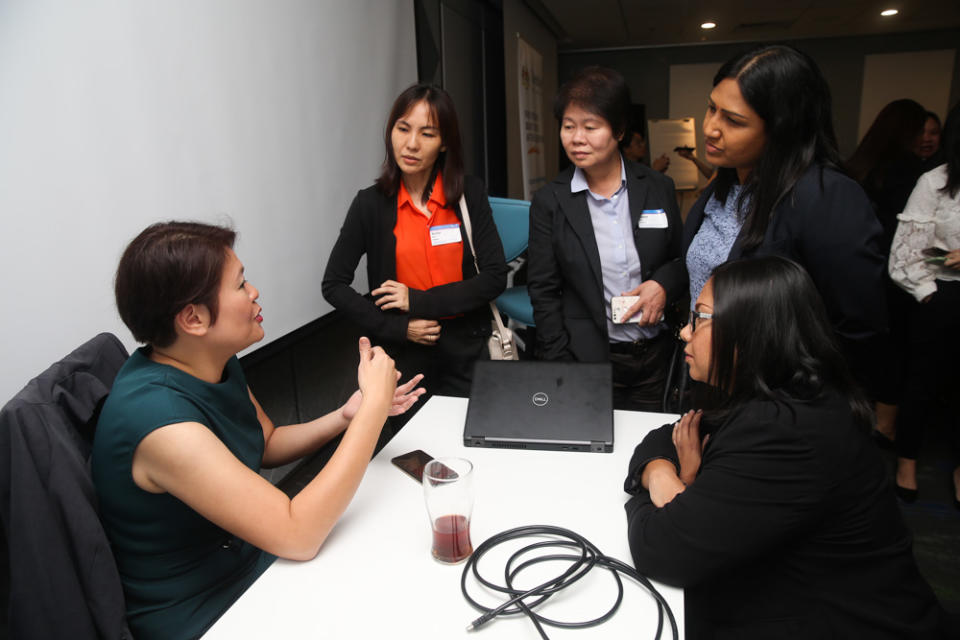 Career Comeback Programme participants getting advice from Baker Hughes APAC senior talent acquisition manager Karen Choe (left) during a workshop on October 29. — Picture by Choo Choy May