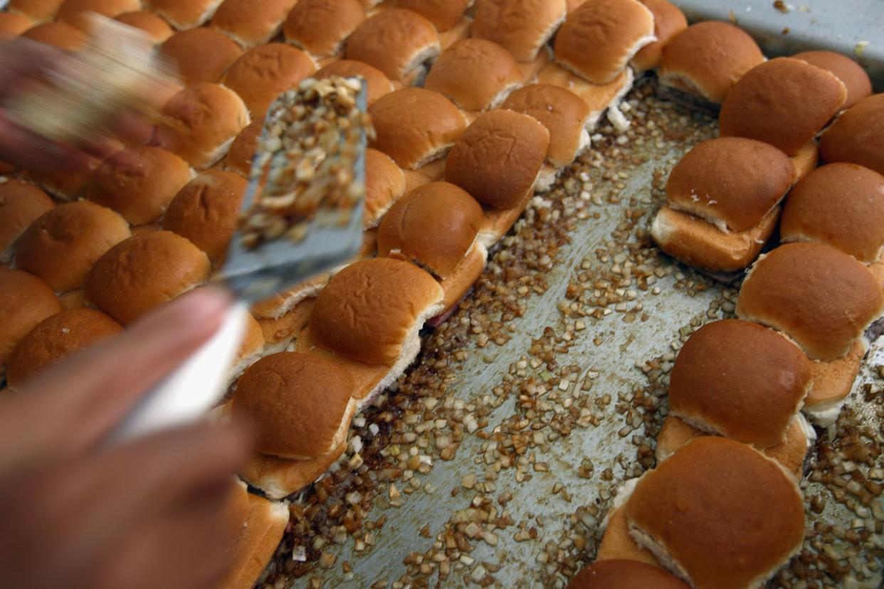 white castle sliders cooking on onions on grill