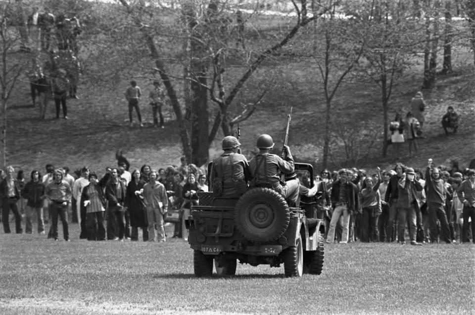 <div class="inline-image__caption"><p>Masked National Guardsmen fired a barrage of tear gas into a crowd of demonstrators on the campus of Kent State University May 4, 1970. When the gas dissipated, four students lay dead and several others injured. </p></div> <div class="inline-image__credit">Bettmann/Getty Images</div>