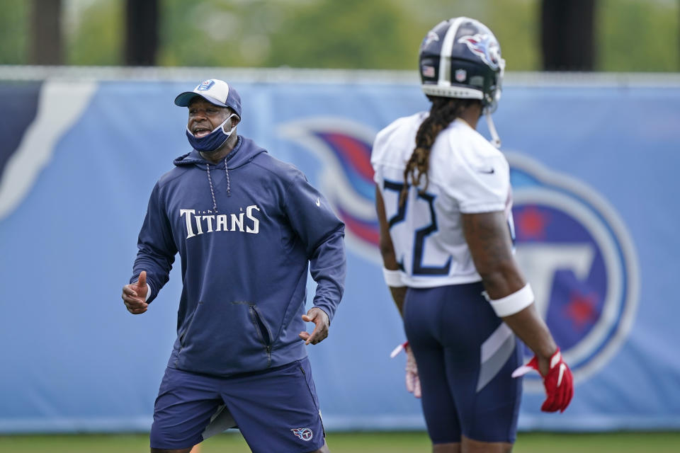 FILE - Tennessee Titans running backs coach Tony Dews, left, instructs players during NFL football training camp, Aug. 16, 2020, in Nashville, Tenn. Two-time NFL rushing champ Derrick Henry absolutely believes his position coach Tony Dews would make a great head coach in the NFL. (AP Photo/Mark Humphrey, File)