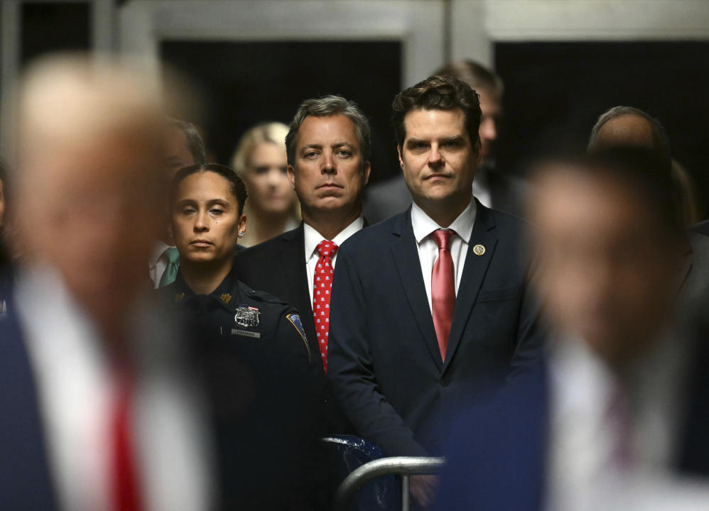 Representatives Andy Ogles of Tennessee and Matt Gaetz of Florida watch as former President Donald Trump speaks to the press before entering the courtroom for his criminal hush money trial in Manhattan.