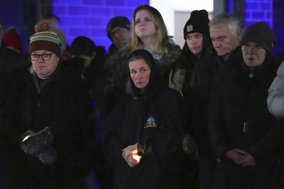 People attend a candlelight vigil after two police officers and a first responder were shot and killed Sunday, Feb. 18, 2024, in Burnsville, Minn. (AP Photo/Abbie Parr)