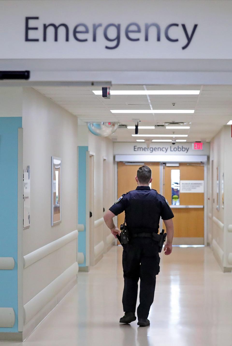 A police officer roams the hallways of Akron Children's Hospital.