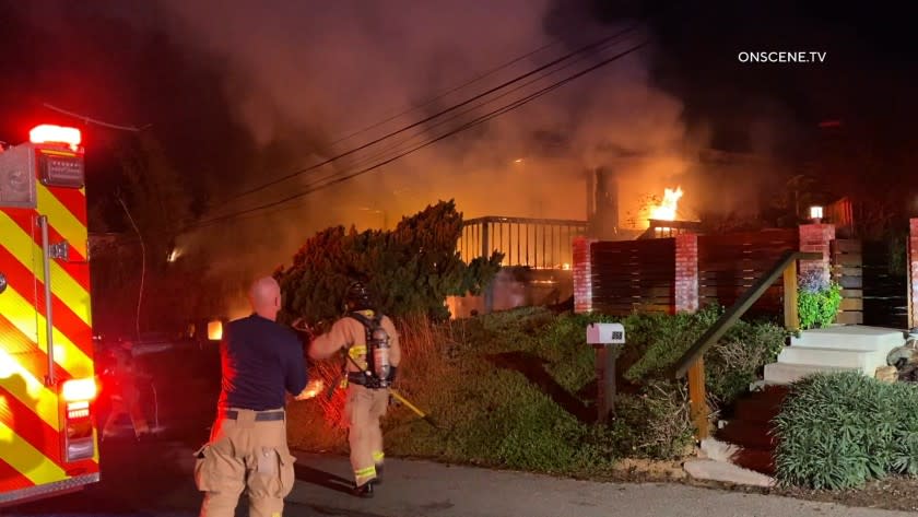 Flames heavily damaged two homes on Stafford Avenue in Encinitas Friday morning.