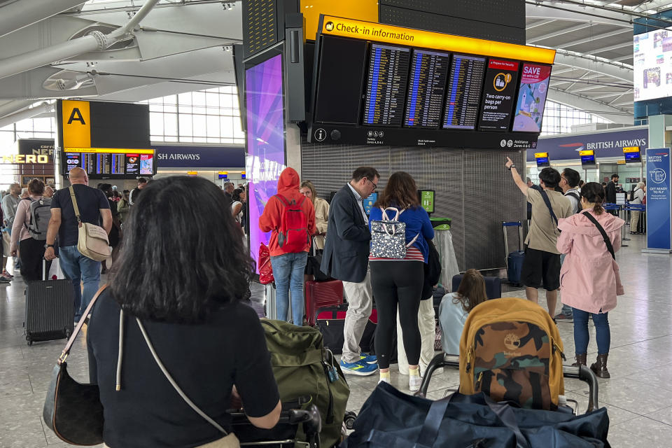 Passengers look at the departures board at Heathrow Airport, in London, Monday, Aug. 28, 2023. Britain’s air traffic control system says it is experiencing a “technical issue” that could delay flights on Monday, the end of a holiday weekend and a busy day for air travel. (AP Photo/Alberto Pezzali)