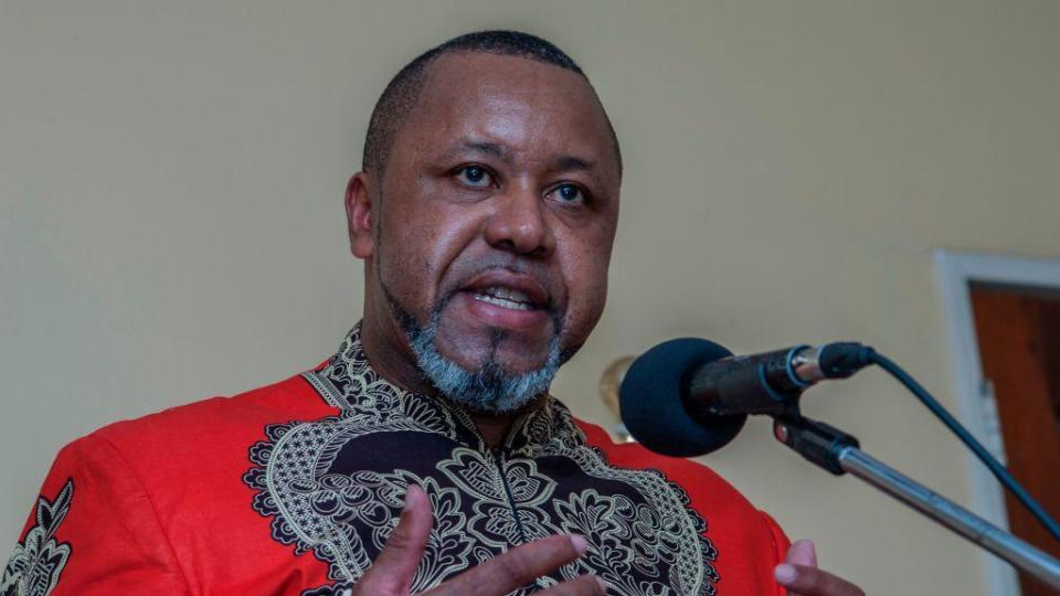 Malawi's former vice president Saulos Chilima wears a red and black African print shirt