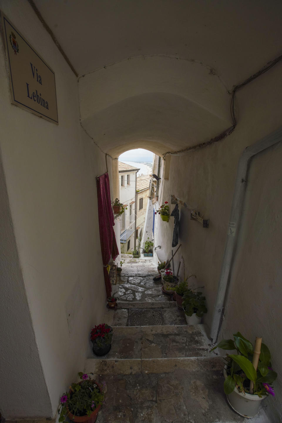 This picture taken on Tuesday, April 28, 2020 shows a narrow alley in the seaside town of Sperlonga, some 120km (80 miles) south of Rome. Normally, at this time of year Sperlonga would already be bustling with its first clients of the season. The restaurants would be fully operational and the golden-sand beaches, although still too chilly for Italians, would have been enjoyed by northern Europeans eager for some sunlight after a long, dark winter. (AP Photo/Andrew Medichini)