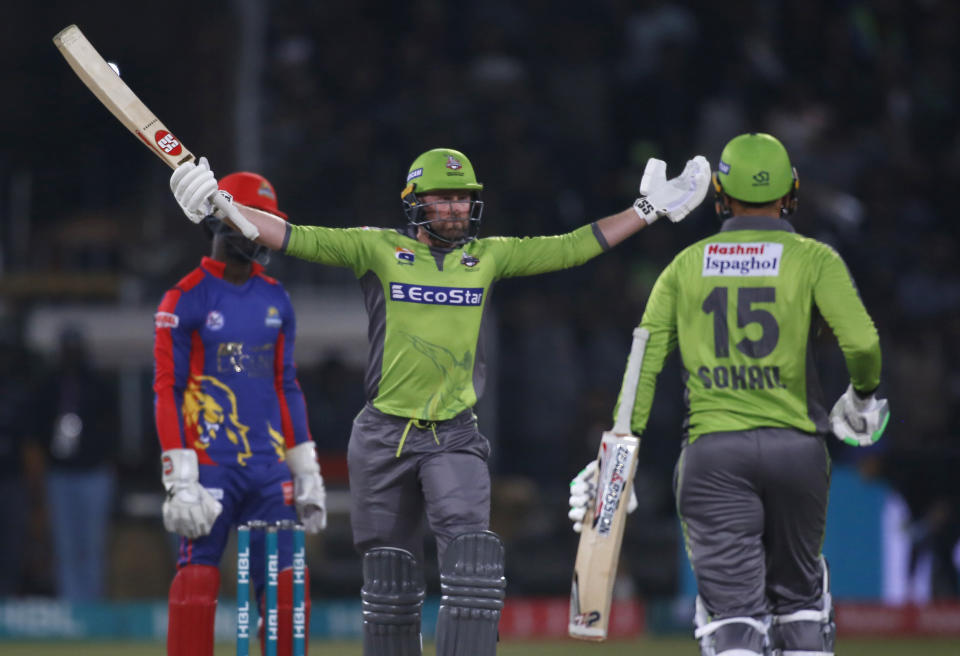 Lahore Qalandars batsman Ben Dunk, center, reacts after scoring winning run during a Pakistan Super League T20 cricket match against Karachi Kings, in Lahore, Pakistan, Sunday, March 8, 2020.(AP Photo/K.M. Chaudary)