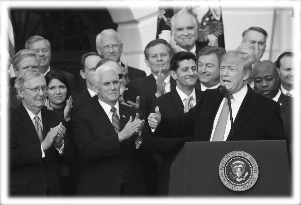 President Trump, with Vice President Mike Pence and members of Congress, speaks about the passage of the tax overhaul bill in December 2017. (Photo: Manuel Balce Ceneta/AP)