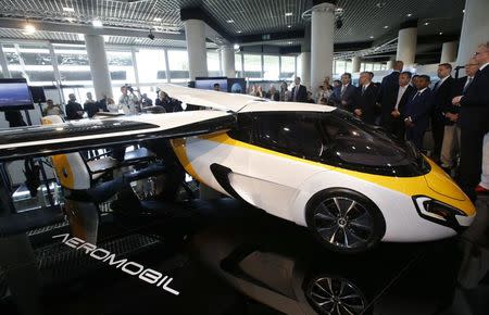 People look at the AeroMobil flying car during its unveiling at the Top Marques Monaco supercar show in Monaco April 20, 2017. REUTERS/Jean-Paul Pelissier