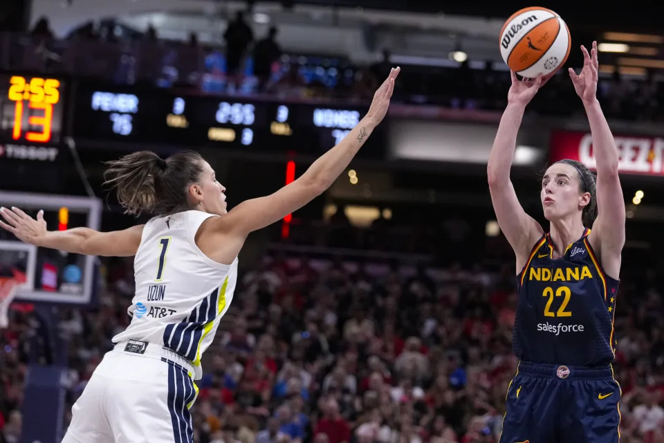 Indiana Fever guard Caitlin Clark (22) shoots over Dallas Wings guard Sevgi Uzun (1) in the second half of a WNBA basketball game in Indianapolis, Sunday, Sept. 15, 2024. (AP Photo/Michael Conroy)