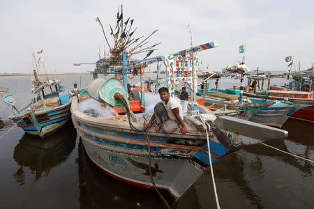 Fisherman Abdul Hameed, a Rohingya Muslim living in Pakistan, sits on a fishing boat at the fish harbour in Ibrahim Hydri in Karachi, Pakistan September 7, 2017. Picture taken September 7, 2017. REUTERS/Akhtar Soomro