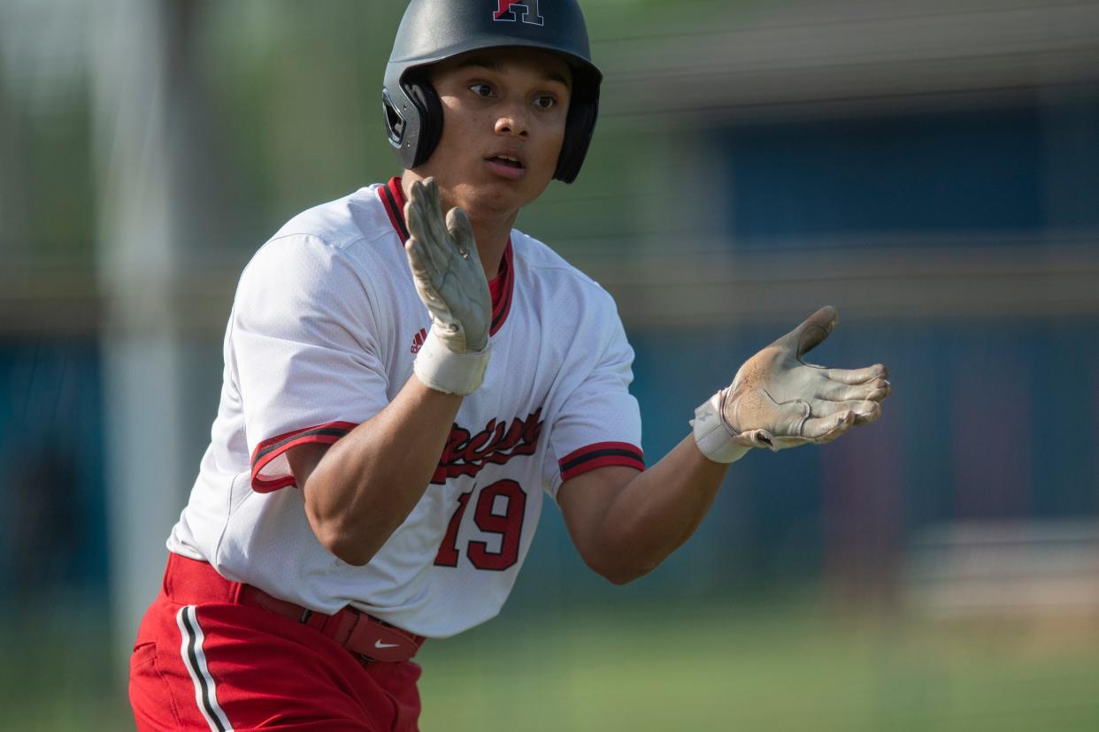 Harrison’s Kaleb Bard (19) celebrates a walk as the Castle Knights play the Harrison Warriors in Newburgh, Ind., Thursday, April 18, 2024.