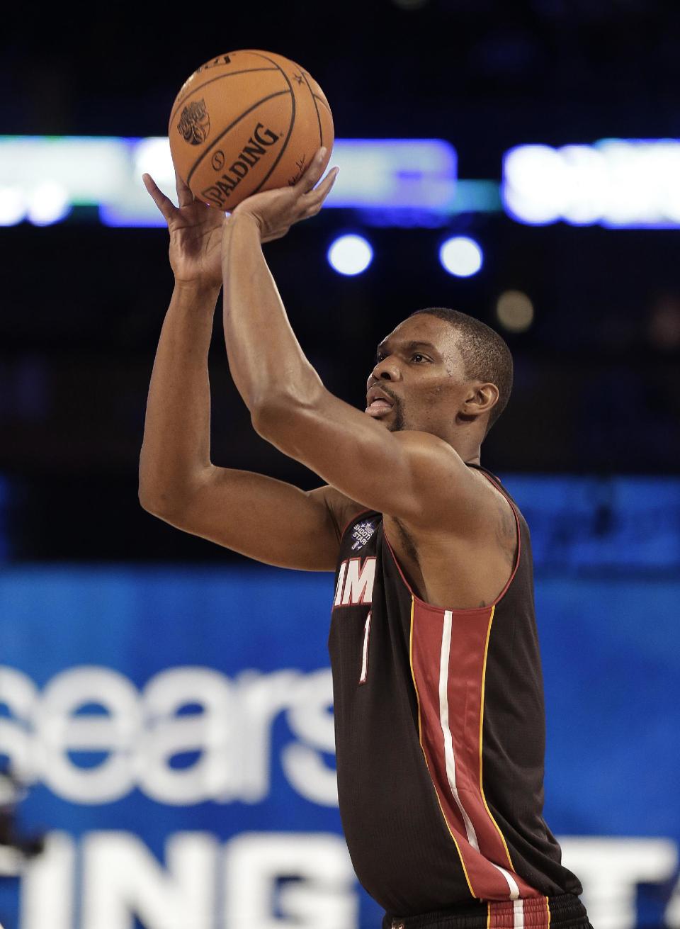 Chris Bosh, of the Miami Heat (1) shoots during the skills competition at the NBA All Star basketball game, Saturday, Feb. 15, 2014, in New Orleans. (AP Photo/Gerald Herbert)