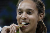 FILE - United States' Brittney Griner bites her gold medal after beating Spain at the 2016 Summer Olympics in Rio de Janeiro, Brazil, Saturday, Aug. 20, 2016. Griner had for years been known to fans of women's basketball, college player of the year, a two-time Olympic gold medalist and WNBA all-star who dominated her sport. But her arrest on drug-related charges at a Moscow airport in February elevated her profile in ways neither she nor her supporters would have ever hoped for, making her by far the most high-profile American to be jailed abroad. (AP Photo/Eric Gay, File)