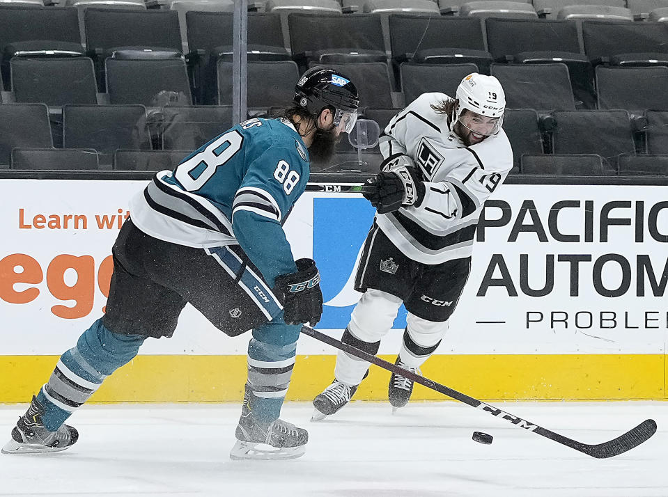 Los Angeles Kings right wing Alex Iafallo (19) takes a shot at goal past San Jose Sharks defenseman Brent Burns (88) during the second period of an NHL hockey game Friday, April 9, 2021, in San Jose, Calif. (AP Photo/Tony Avelar)