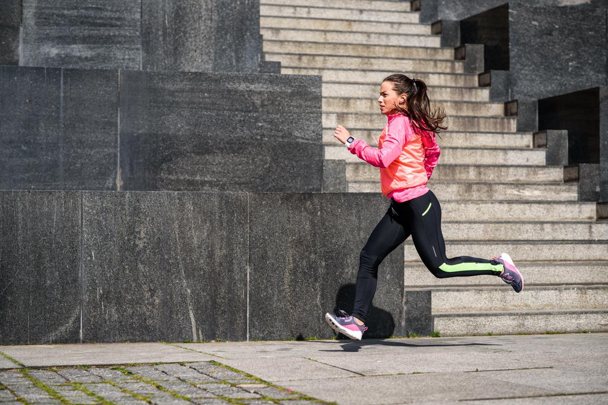 woman running outside in city