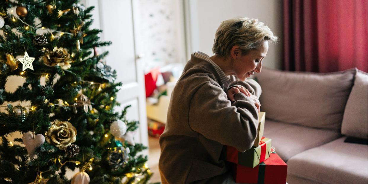 sad woman by Christmas tree infertility during holidays