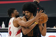 Toronto Raptors center Khem Birch (24) guards Cleveland Cavaliers center Jarrett Allen (31) during the second half of an NBA basketball game Monday, April 26, 2021, in Tampa, Fla. (AP Photo/Chris O'Meara)