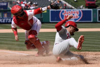 Los Angeles Angels catcher Matt Thaiss, right, tags out Philadelphia Phillies' Whit Merrifield at home plate during the seventh inning of a baseball game in Anaheim, Calif., Wednesday, May 1, 2024. (AP Photo/Alex Gallardo)