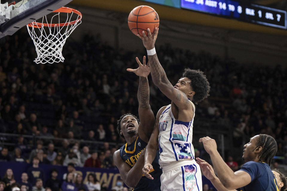 Washington forward Keion Brooks Jr. shoots over California guard Jalen Celestine during the second half of an NCAA college basketball game Saturday, Feb. 17, 2024, in Seattle. California won 82-80. (AP Photo/Stephen Brashear)