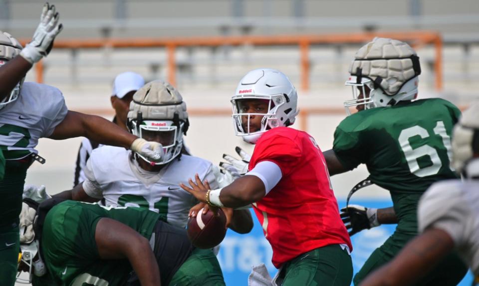 Florida A&M University quarterback Rasean McKay attempts a pass while under pressure in team’s first fall scrimmage, Aug. 6, 2022