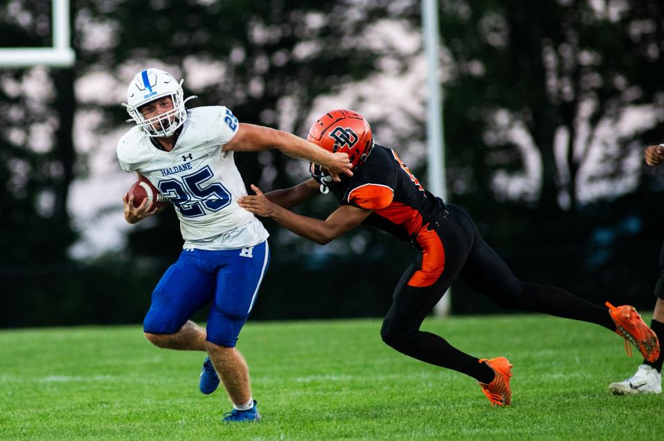 Haldane's Evan Giachinta fends off a Dover defender during the Week 0 high school football game in Dover Plains on Friday, September 1, 2023.