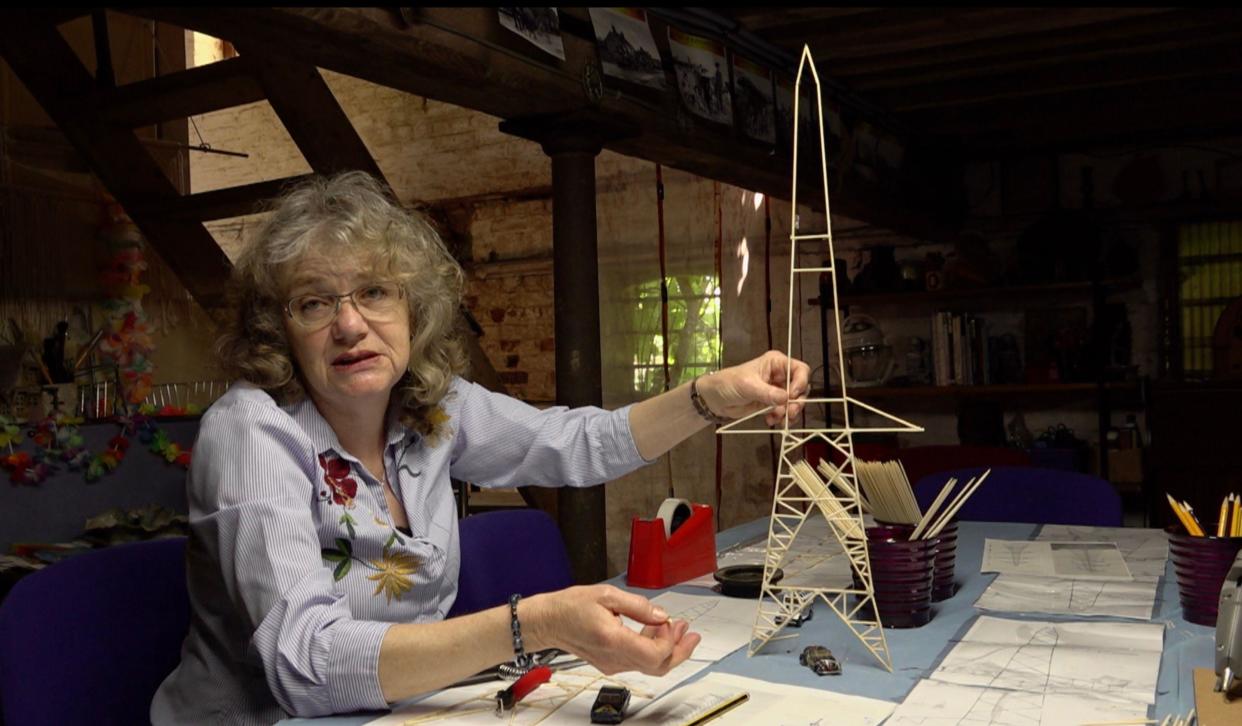 Nicola Hughes touches the pylon model with her left hand