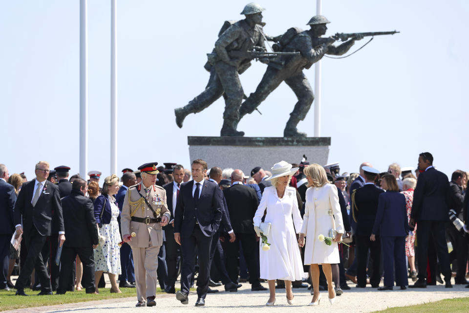 From left, Britain's King Charles III, President of France Emmanuel Macron, Queen Camilla, and Brigitte Macron walk, during the UK Ministry of Defence and the Royal British Legion's commemorative event at the British Normandy Memorial to mark the 80th anniversary of D-Day, in Ver-Sur-Mer, France, Thursday, June 6, 2024. (Chris Jackson, Pool Photo via AP)