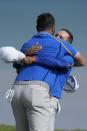 Team Europe's Jon Rahm and Team Europe's Sergio Garcia react after winning their foursome match the Ryder Cup at the Whistling Straits Golf Course Friday, Sept. 24, 2021, in Sheboygan, Wis. (AP Photo/Ashley Landis)