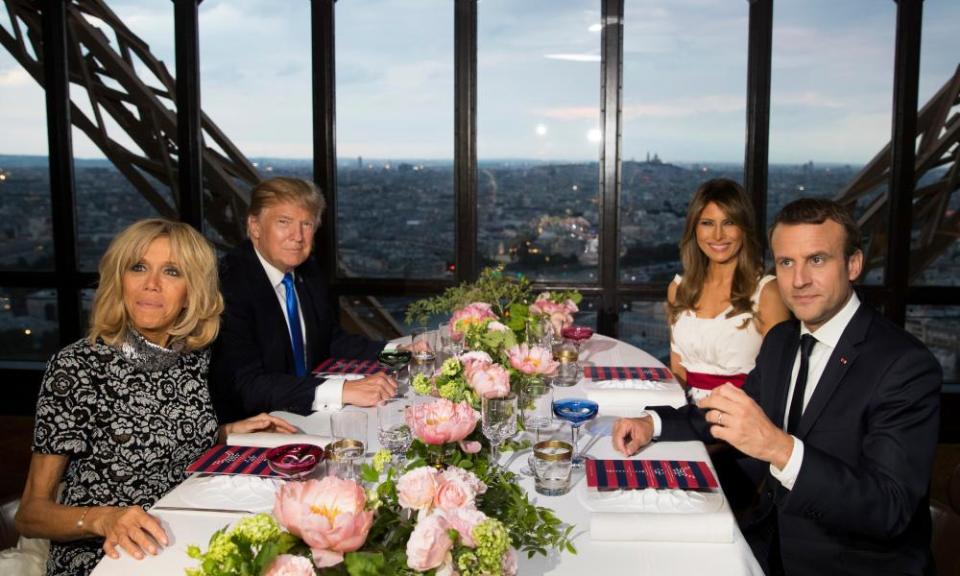 Donald and Melania Trump sit for dinner with the French president Emmanuel Macron and his wife Brigitte Macron at the Jules Verne restaurant at the Eiffel Tower on 13 July 2017.