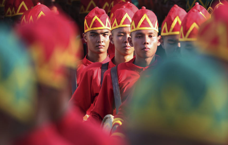 The royal guard march during Thailand's King Maha Vajiralongkorn during the Royal Procession on Land touring the neighborhood streets during the second day of the coronation ceremony, Sunday, May 5, 2019, in Bangkok, Thailand. (AP Photo/Sakchai Lalit)