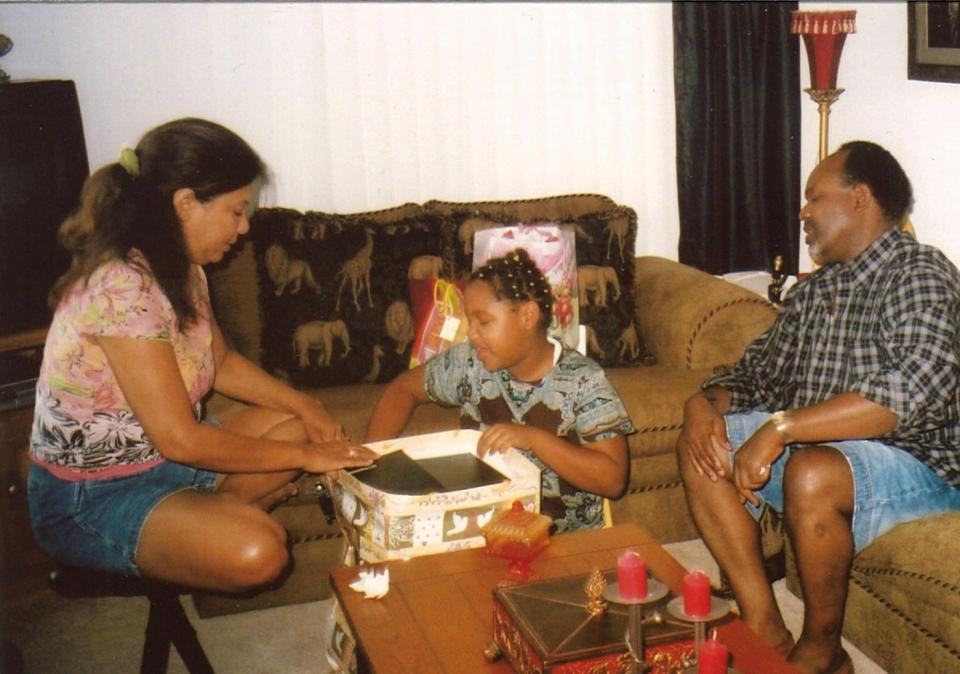 Enquirer reporter Haadiza Ogwude with her parents Gina and Emmanuel Ogwude on Christmas Day 2006.