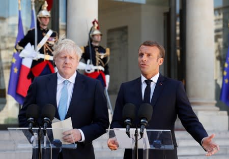 French President Emmanuel Macron and British Prime Minister Boris Johnson deliver a joint statement before a meeting on Brexit at the Elysee Palace in Paris