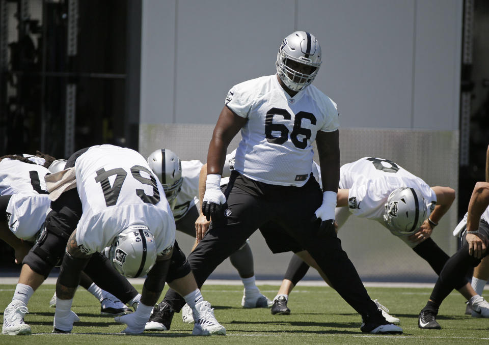 FILE - In this June 11, 2019, file photo, Oakland Raiders offensive guard Gabe Jackson (66) and teammates stretch during the NFL football team's minicamp in Alameda, Calif. The Raiders are concerned about the status of starting right guard Jackson after he injured his leg in a joint practice with the Los Angeles Rams. Jackson went down early in the session Thursday, Aug. 8, when someone rolled into his leg. Jackson was then taken off the field on a cart and owner Mark Davis went into the locker room shortly after that for almost 15 minutes. (AP Photo/Eric Risberg, File)