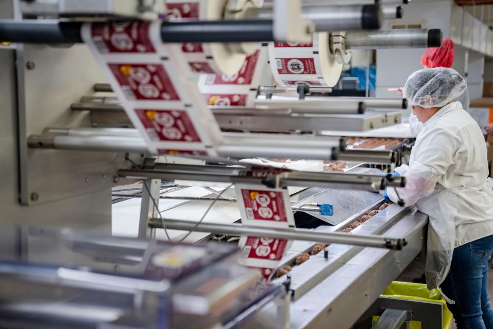 Handmade Twin Bing are fed into wrappers at the Palmer Candy factory in Sioux City.