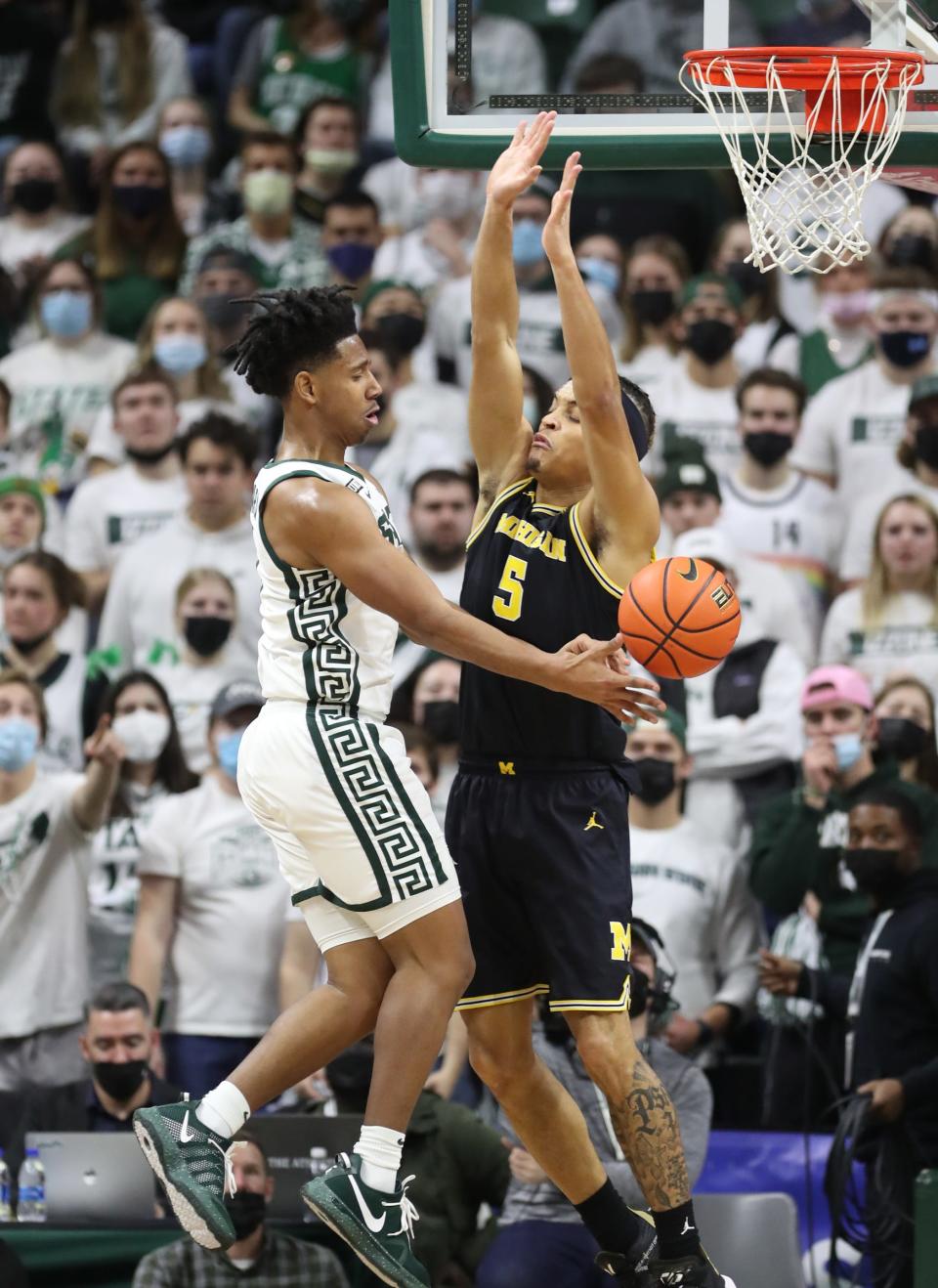 Michigan State Spartans guard A.J. Hoggard (11) looks to pass against Michigan Wolverines forward Terrance Williams II (5) during first half action Saturday, Jan. 29, 2022 at the Breslin Center.