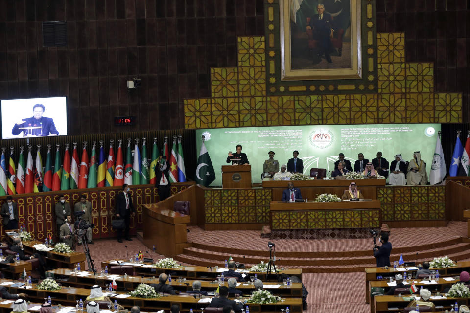 Pakistan Prime Minister Imran Khan, center, speaks during the 17th extraordinary session of Organization of Islamic Cooperation (OIC) Council of Foreign Ministers, in Islamabad, Pakistan, Sunday, Dec. 19, 2021. The economic collapse of Afghanistan, already teetering dangerously on the edge, would have a "horrendous" impact on the region and the world, successive speakers warned Sunday at the start of a one-day summit of foreign ministers. (AP Photo/Rahmat Gul)