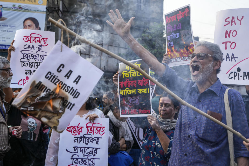 Activists and supporters of Communist Party of India (Marxist-Leninist) burn a copy of the the Citizenship Amendment Act (CAA) during a protest against CAA in Kolkata, India, Tuesday, March 12, 2024. India has implemented a controversial citizenship law that has been widely criticized for excluding Muslims, a minority community whose concerns have heightened under Prime Minister Narendra Modi's Hindu nationalist government. The act provides a fast track to naturalization for Hindus, Parsis, Sikhs, Buddhists, Jains and Christians who fled to Hindu-majority India from Afghanistan, Bangladesh and Pakistan before Dec. 31, 2014. (AP Photo/Bikas Das)